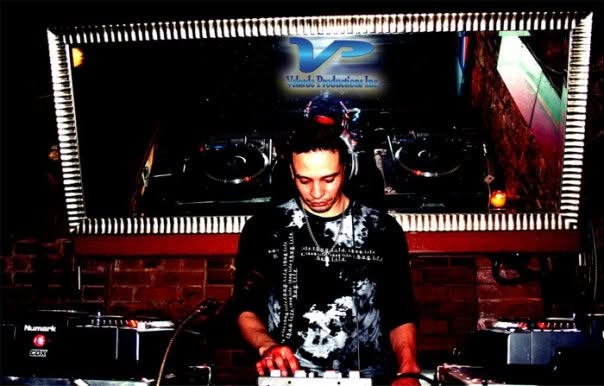 Ray Velarde performing behind a set of DJ decks