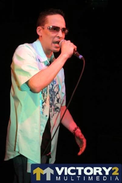 Ray Velarde singing live into a microphone